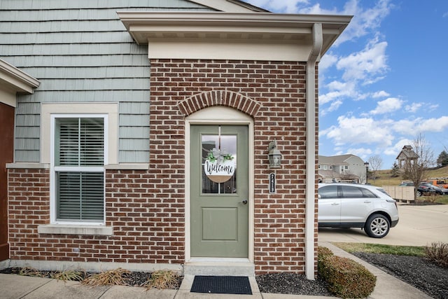 property entrance with brick siding