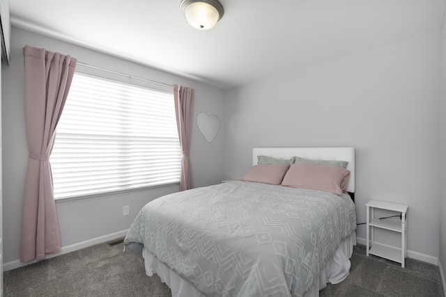 carpeted bedroom with visible vents and baseboards