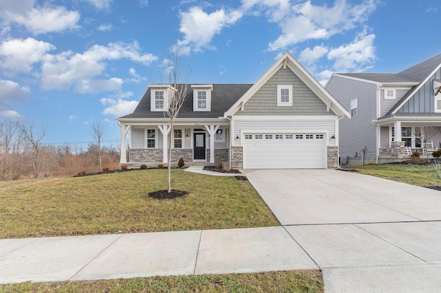 view of front of home featuring a porch, concrete driveway, a front yard, a garage, and stone siding