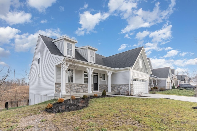 view of front of home featuring fence, covered porch, a front lawn, concrete driveway, and a garage