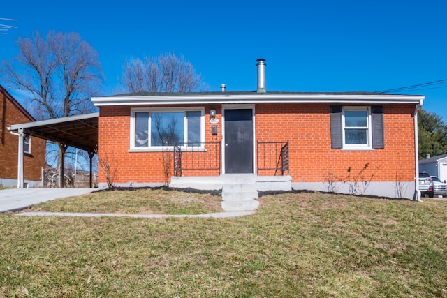 view of front of home with driveway, a front lawn, and brick siding