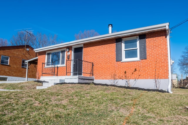 view of front of property with a front lawn and brick siding