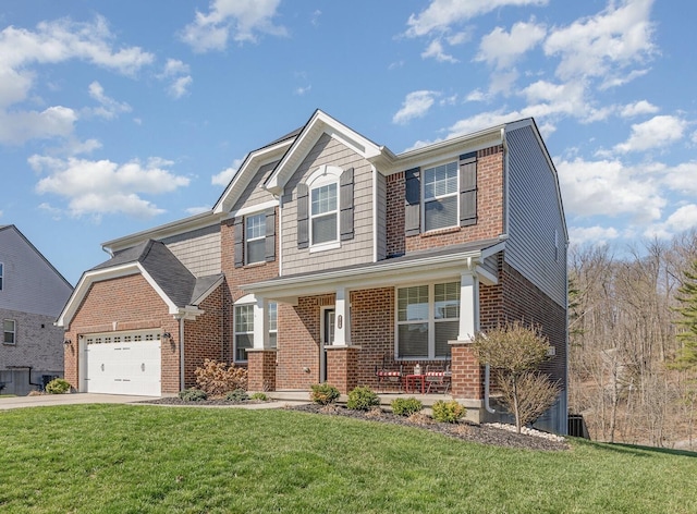 view of front of property with driveway, an attached garage, covered porch, a front lawn, and brick siding