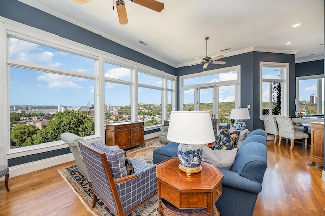 sunroom featuring visible vents and ceiling fan