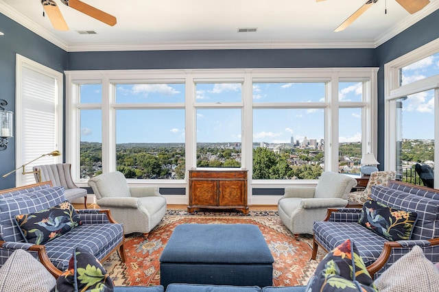 sunroom with a view of city, visible vents, and a ceiling fan