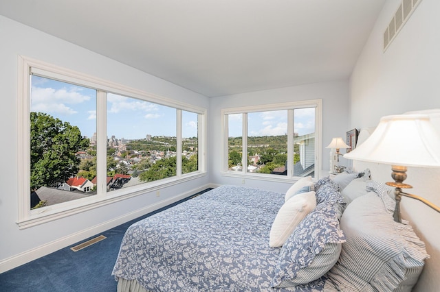 carpeted bedroom with visible vents and baseboards