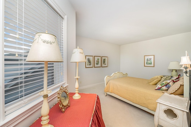 bedroom with carpet floors and baseboards