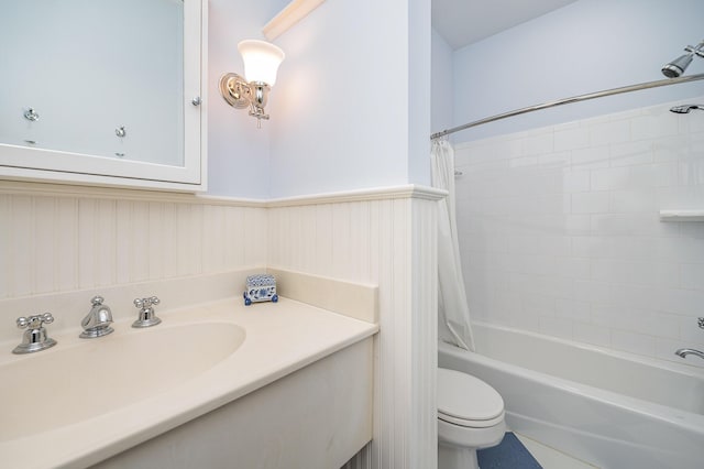 full bathroom featuring wainscoting, vanity, toilet, and shower / bathtub combination with curtain