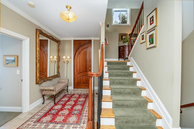 entryway featuring stairs, baseboards, and crown molding