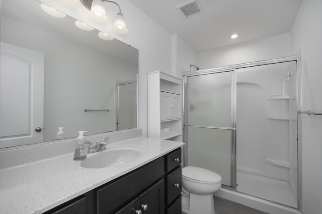 full bathroom featuring visible vents, a shower stall, toilet, and vanity