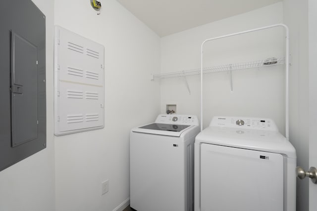 laundry area featuring laundry area, washer and clothes dryer, and electric panel