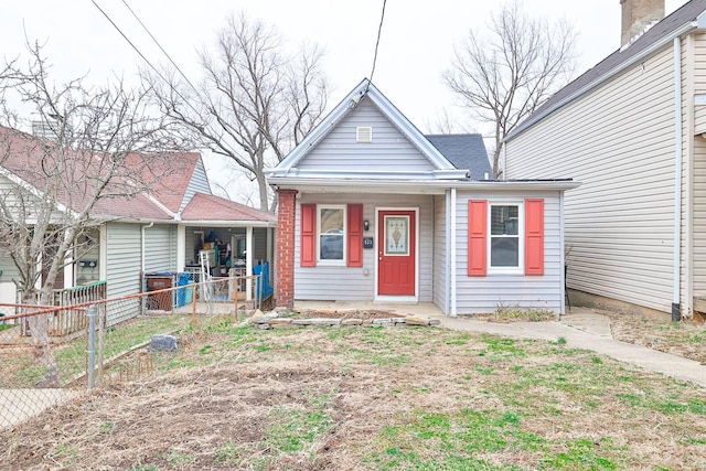 bungalow-style house with a porch and fence