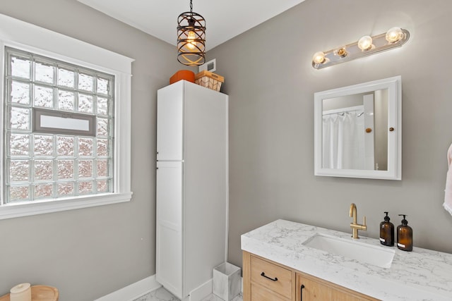 bathroom featuring vanity and baseboards