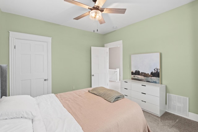 bedroom with a ceiling fan, visible vents, and light colored carpet