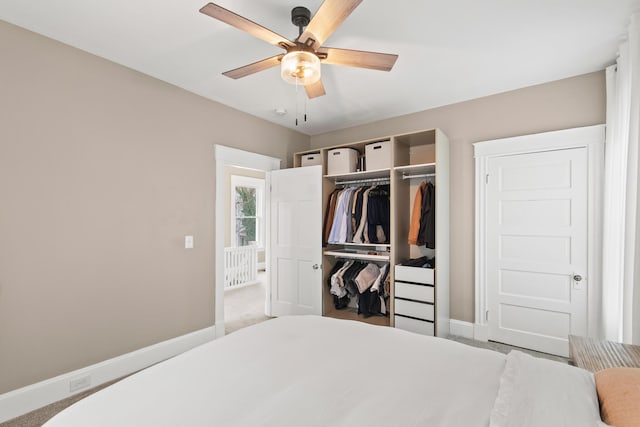 bedroom featuring a ceiling fan, carpet, a closet, and baseboards