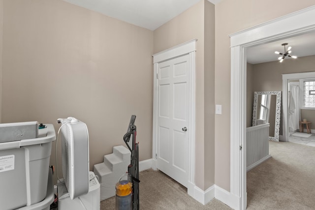 interior space with carpet floors, a notable chandelier, and baseboards