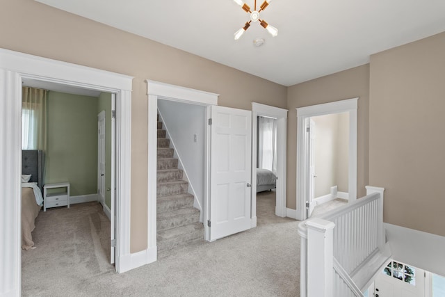 interior space featuring light carpet, stairway, and baseboards