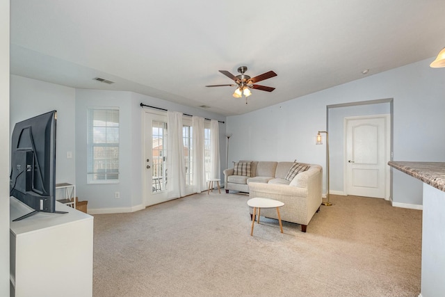 living room with light carpet, baseboards, visible vents, ceiling fan, and vaulted ceiling