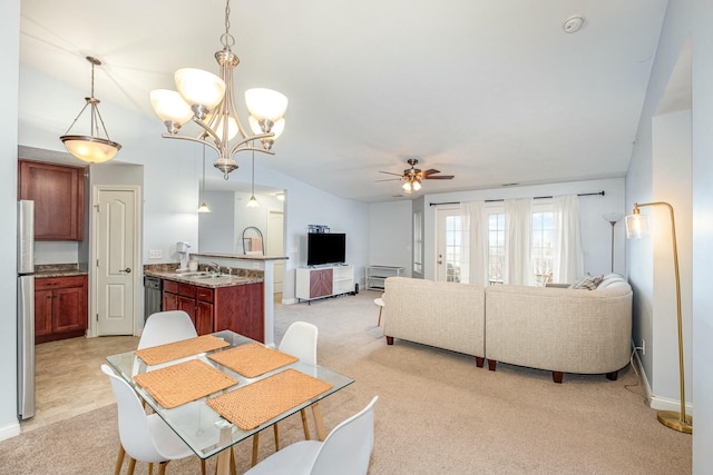 dining space with light carpet and ceiling fan with notable chandelier