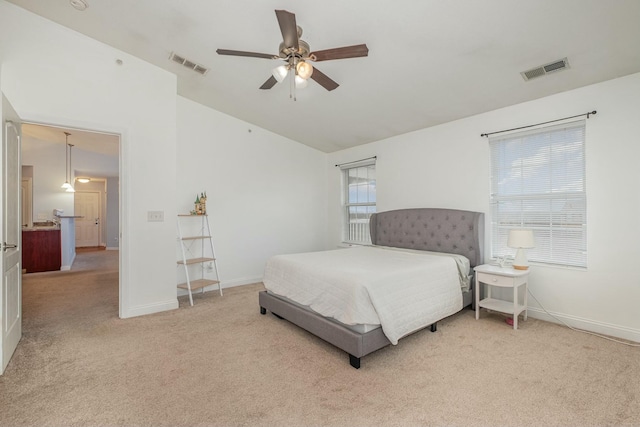 bedroom featuring visible vents, vaulted ceiling, light carpet, and baseboards