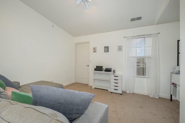 sitting room with light carpet, baseboards, visible vents, and vaulted ceiling