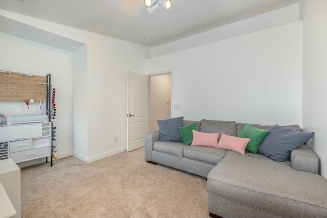 living area featuring carpet and baseboards