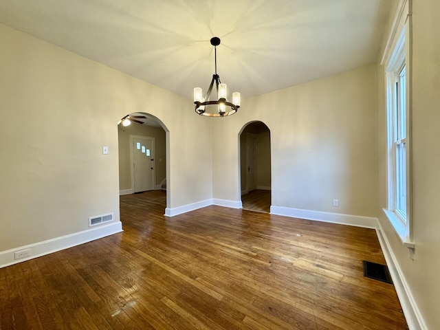 1307 Highway Ave, Covington, KY 41011 - empty room with arched walkways, dark wood-style floors, plenty of natural light, and a chandelier