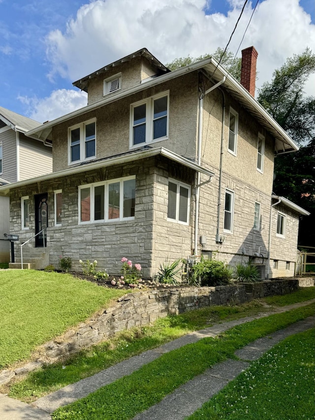 1307 Highway Ave, Covington, KY 41011 - view of side of property with a chimney, stone siding, a yard, and stucco siding