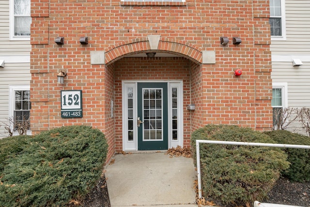 property entrance featuring brick siding