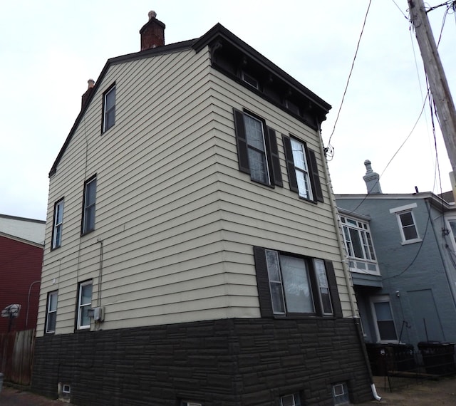 view of home's exterior with a chimney