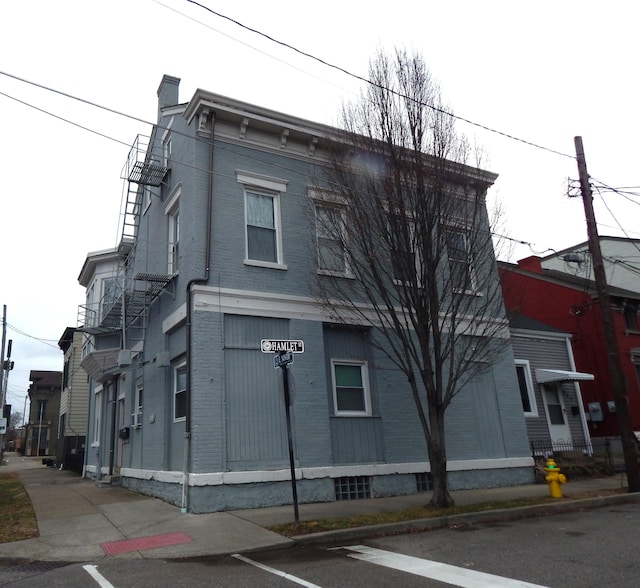 exterior space with a chimney and brick siding