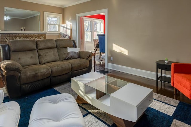 living room with crown molding, baseboards, and wood finished floors