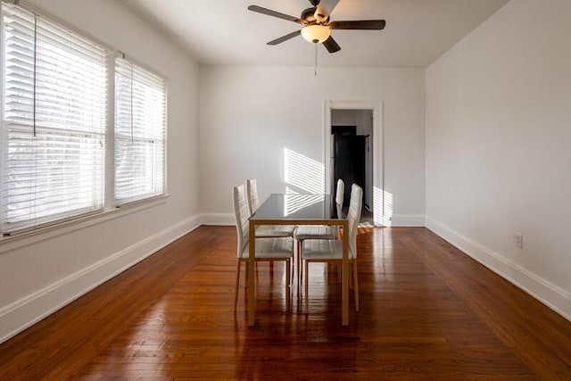 dining room featuring ceiling fan, baseboards, and wood finished floors