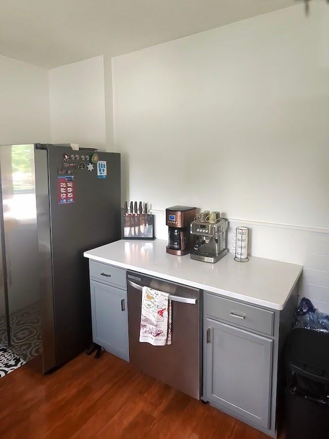 3009 Decoursey Ave, Covington, KY 41015 - kitchen featuring gray cabinetry, stainless steel appliances, dark wood finished floors, and light countertops