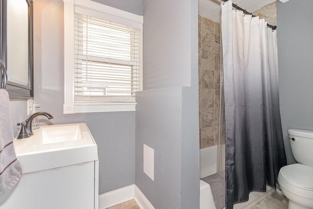 full bath featuring shower / bath combo with shower curtain, vanity, toilet, and baseboards