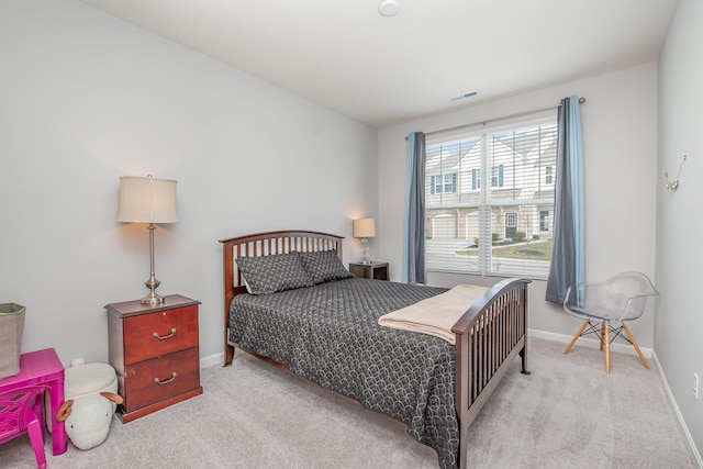 carpeted bedroom featuring visible vents and baseboards