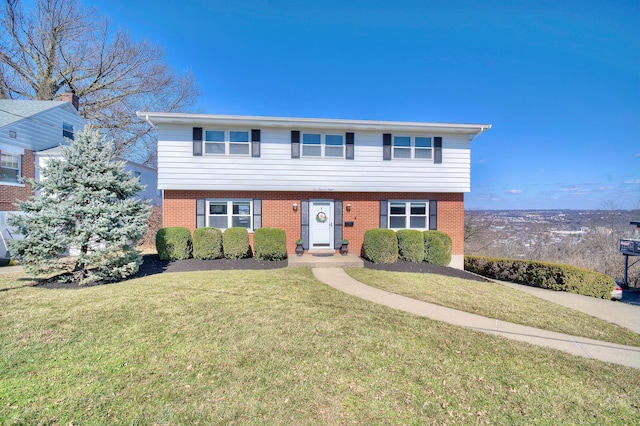 colonial home featuring brick siding and a front lawn