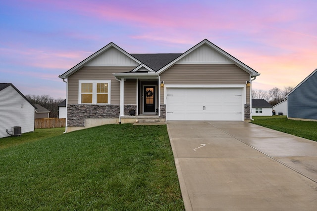 view of front of house featuring central AC unit, a front yard, a garage, stone siding, and driveway