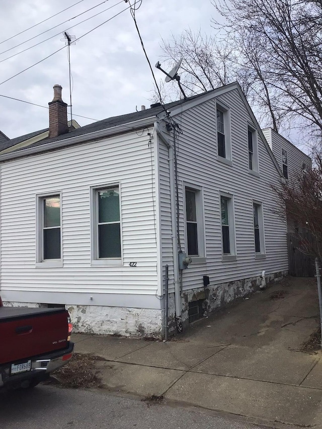 view of side of property with a chimney