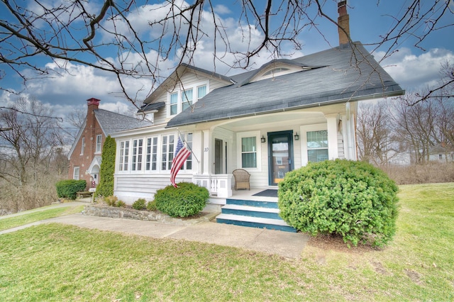 bungalow-style house featuring a porch and a front yard