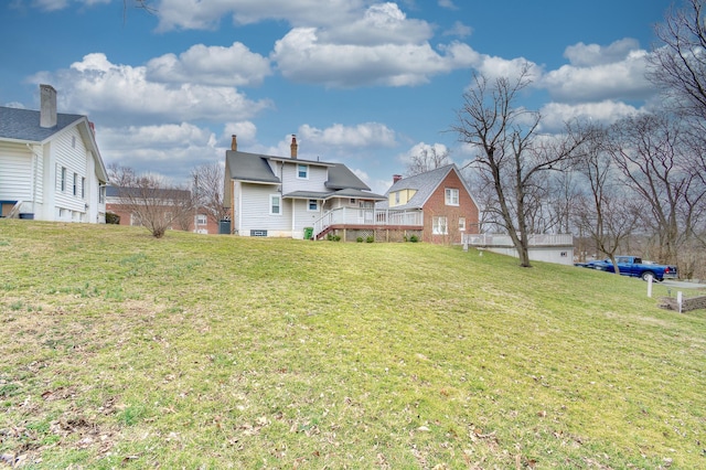 back of property featuring a yard and a wooden deck