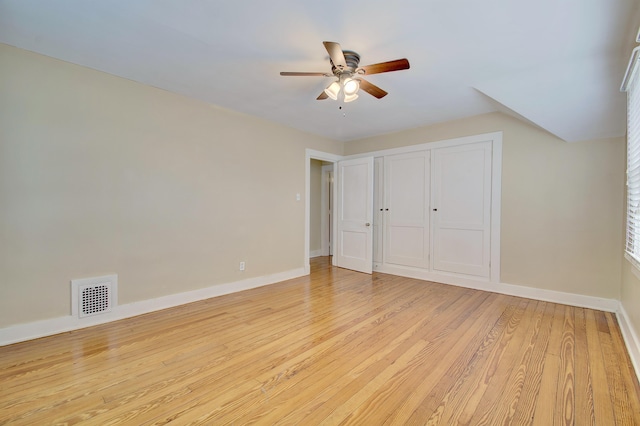 unfurnished bedroom with ceiling fan, light wood finished floors, visible vents, and baseboards