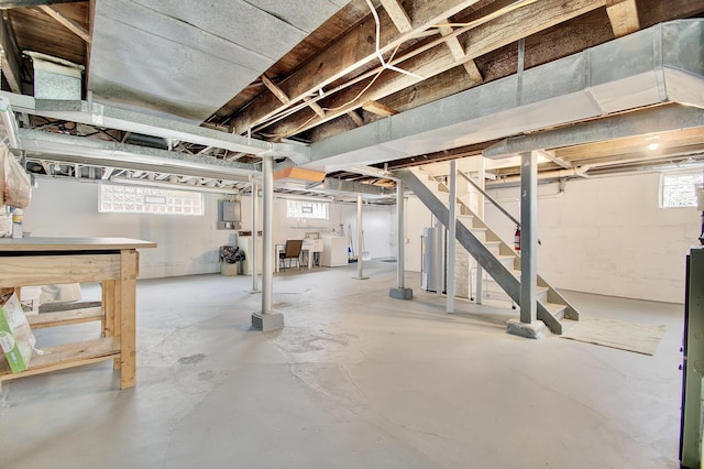 basement with water heater and stairway