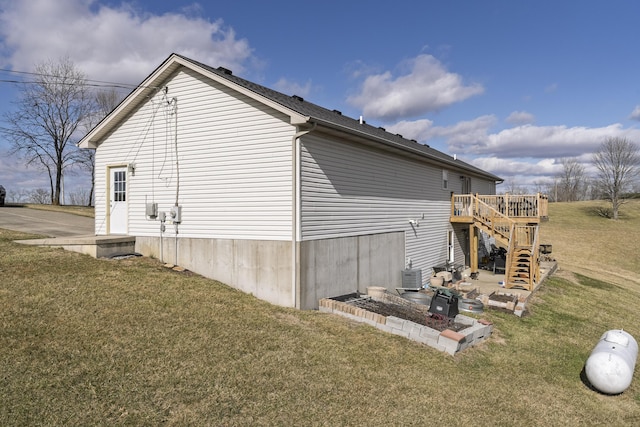 view of side of property with central air condition unit, stairs, a lawn, and a wooden deck