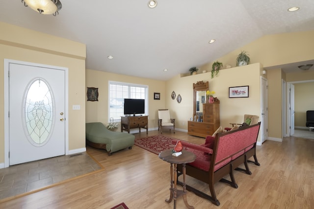 living area featuring light wood-type flooring, lofted ceiling, baseboards, and recessed lighting