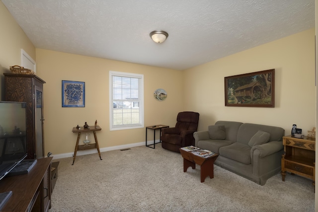 living area with light carpet, visible vents, baseboards, and a textured ceiling