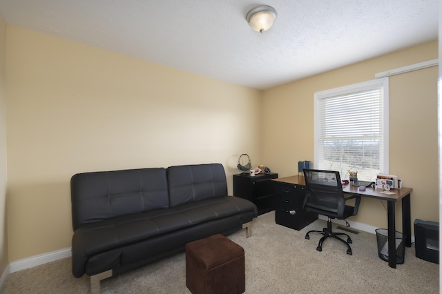 home office featuring a textured ceiling, carpet, and baseboards