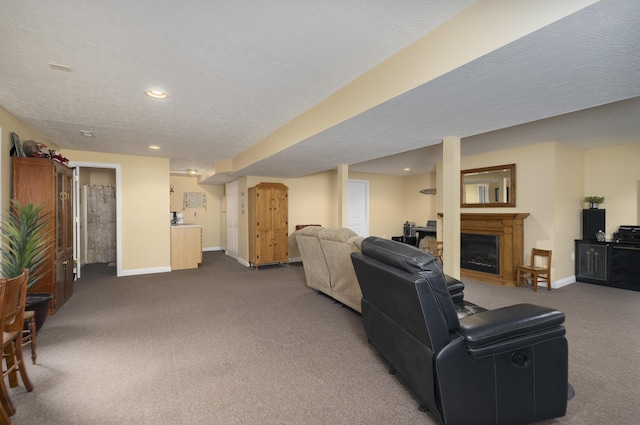 carpeted living area featuring a textured ceiling, recessed lighting, a fireplace, and baseboards