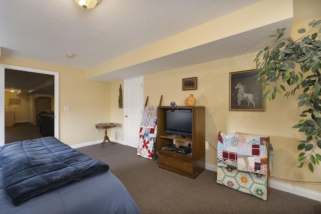 bedroom with dark carpet, a textured ceiling, and baseboards