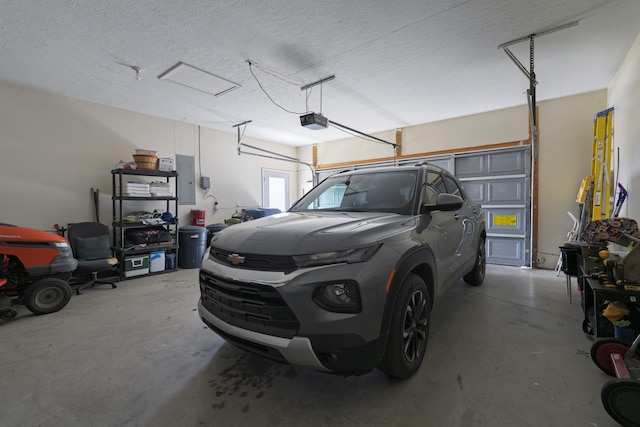 garage with a garage door opener and electric panel